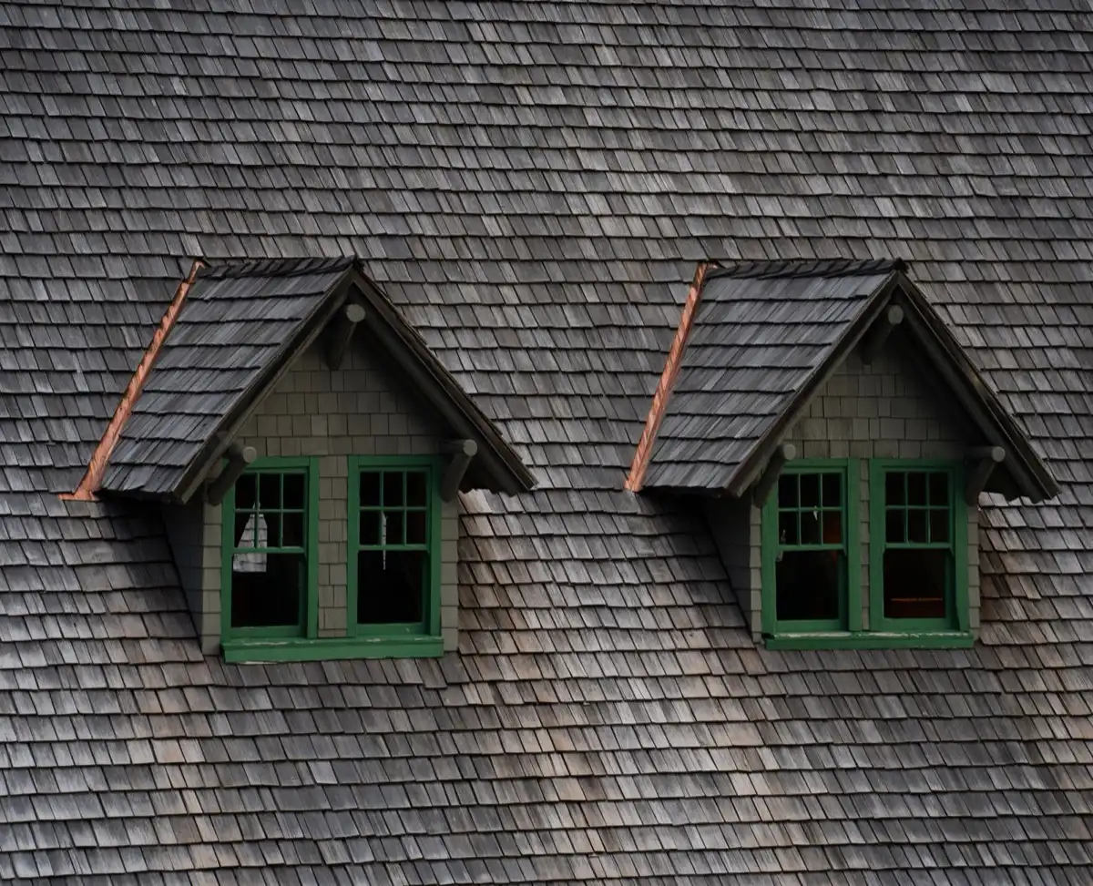Dormers on a shingle roof in Garden Grove, CA, where step flashing and kickout flashing carry water past the walls